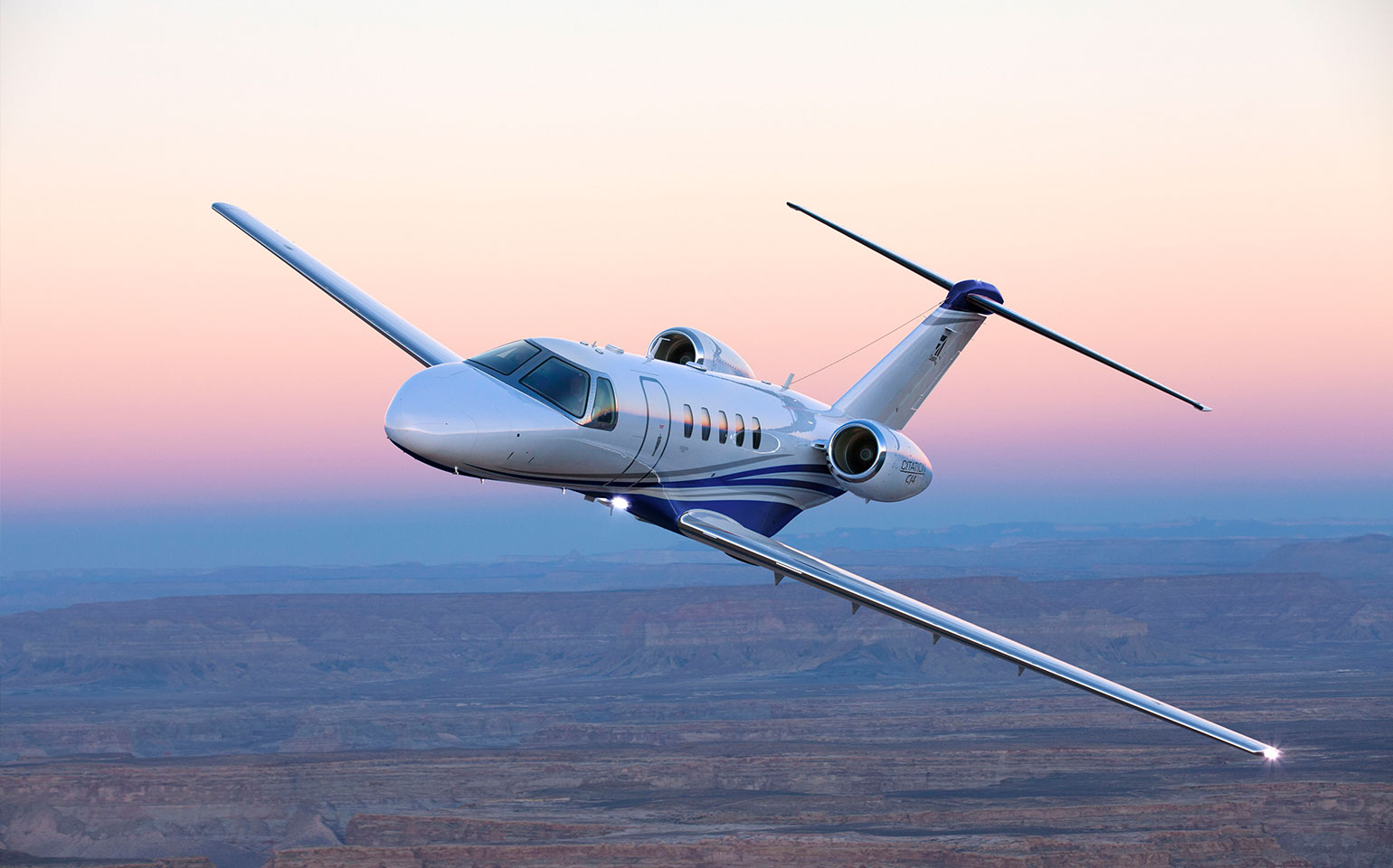 Cessna Citaiton CJ4 private jet charter flying during sunset